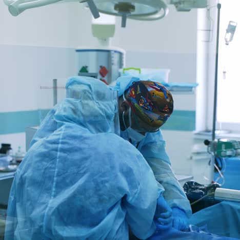 medical workers in blue uniform and safety goggles. doctors in the protective suits and masks are examining the infected patient. covid-19. pandemic.
