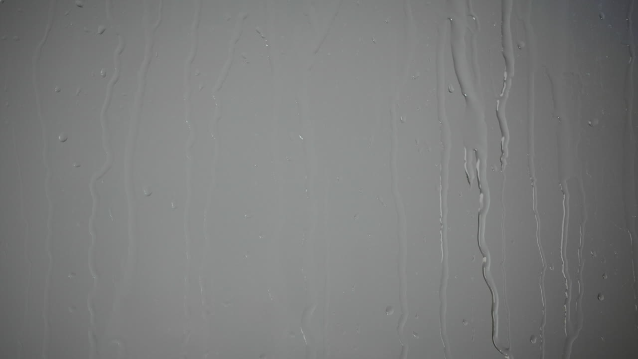 Raindrops Flowing Down a Glass Surface