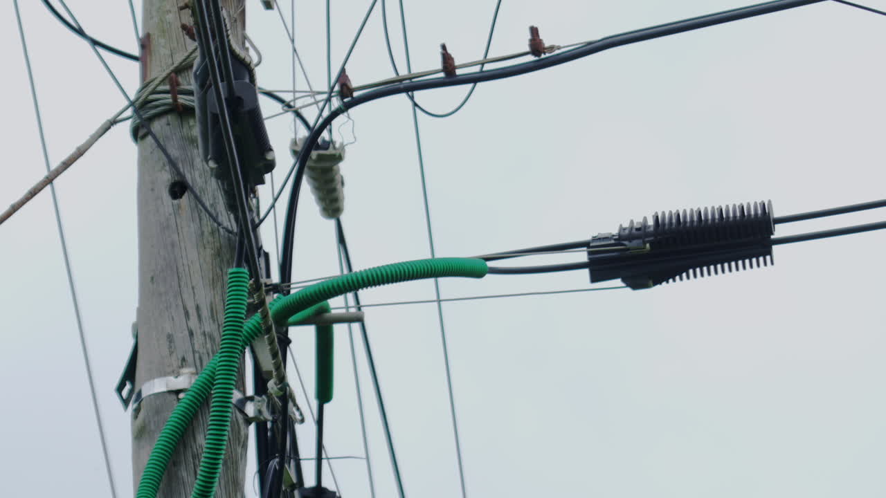 Electricity cable arrangement on a pole.