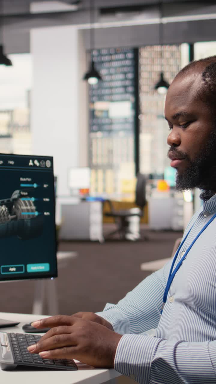 Engineer in office works on wind turbine CAD design, sustainable energy research