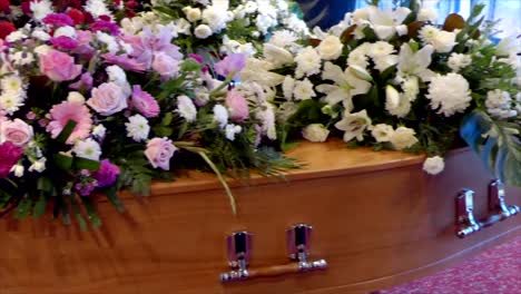 closeup shot of a funeral casket in a hearse or chapel or burial at cemetery