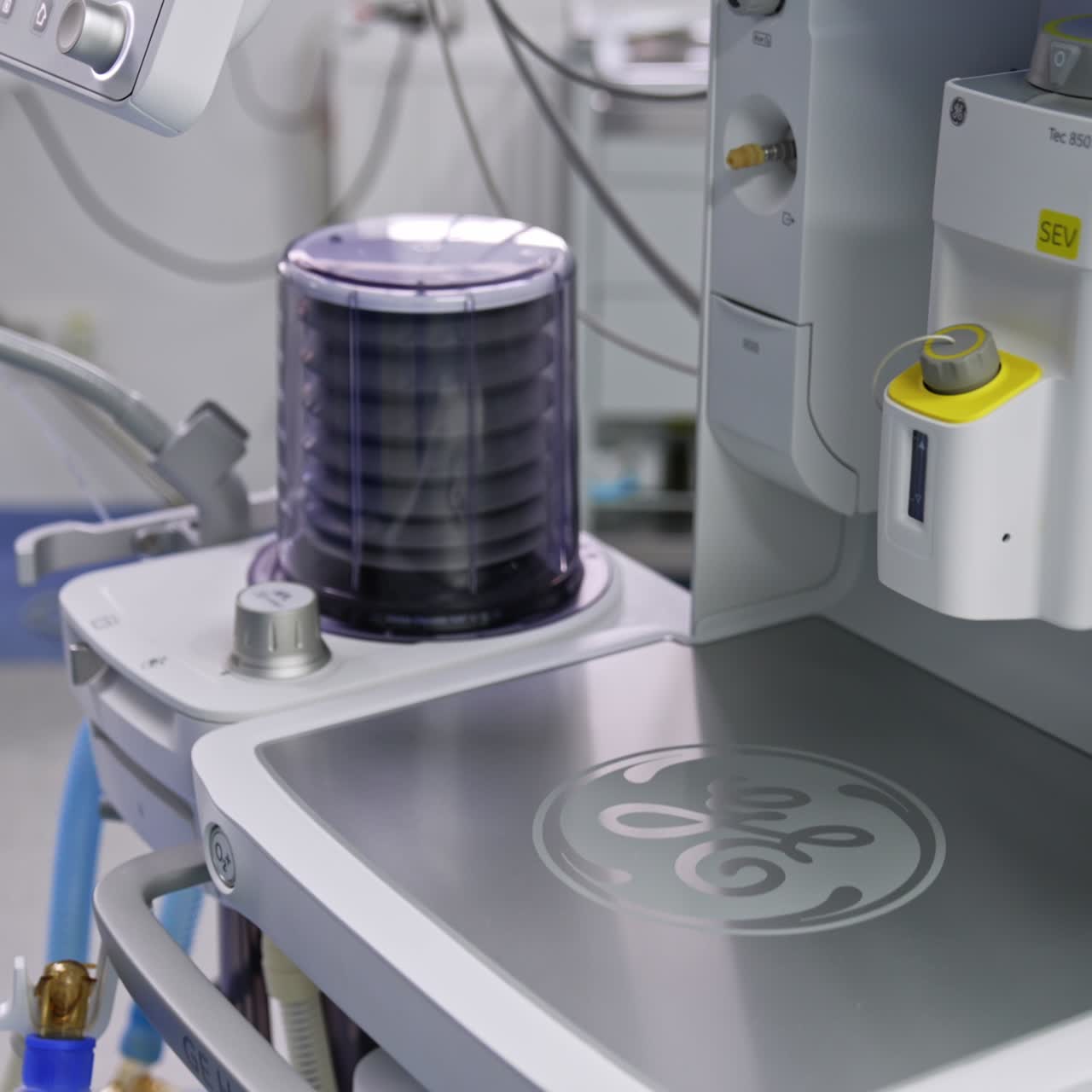 Medic in blue uniform demonstrating the modern artificial lung ventilator machine. Close up. Equipment working in surgical room