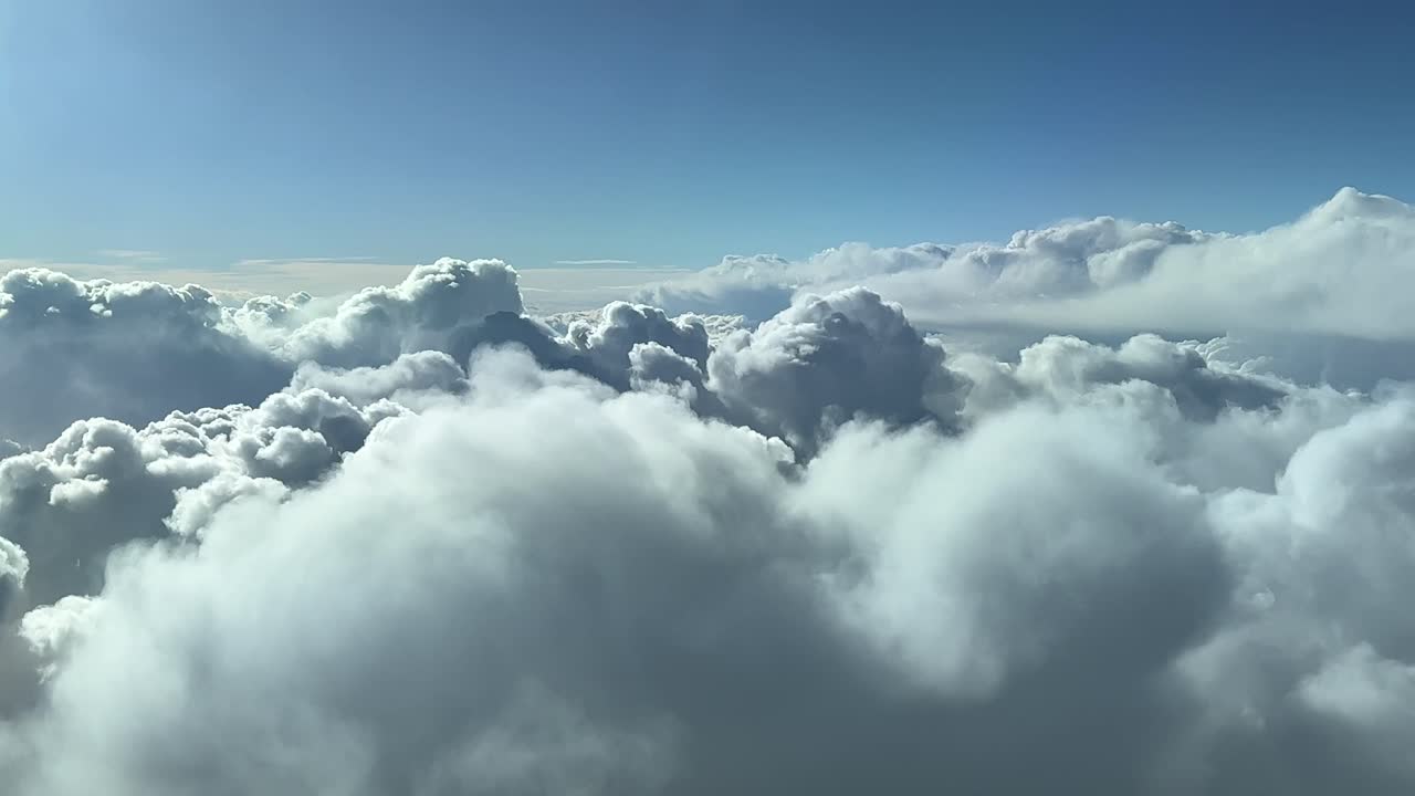 A pilot&rsquo;s perspective flying over a stormy sky full of cumulus clouds