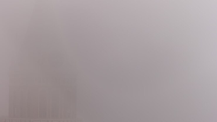 The clock hand spinning on a church or building tower on a foggy day in San Francisco - time lapse