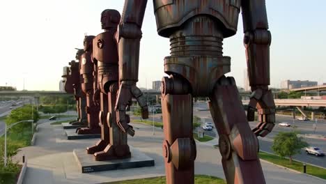 a stunning display of monumental metal figures standing tall in a modern urban landscape: exploring artistic expression through unique sculptural design