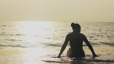 Silueta-De-Mujer-Descansando-En-Olas-Del-Mar-A-Cámara-Lenta