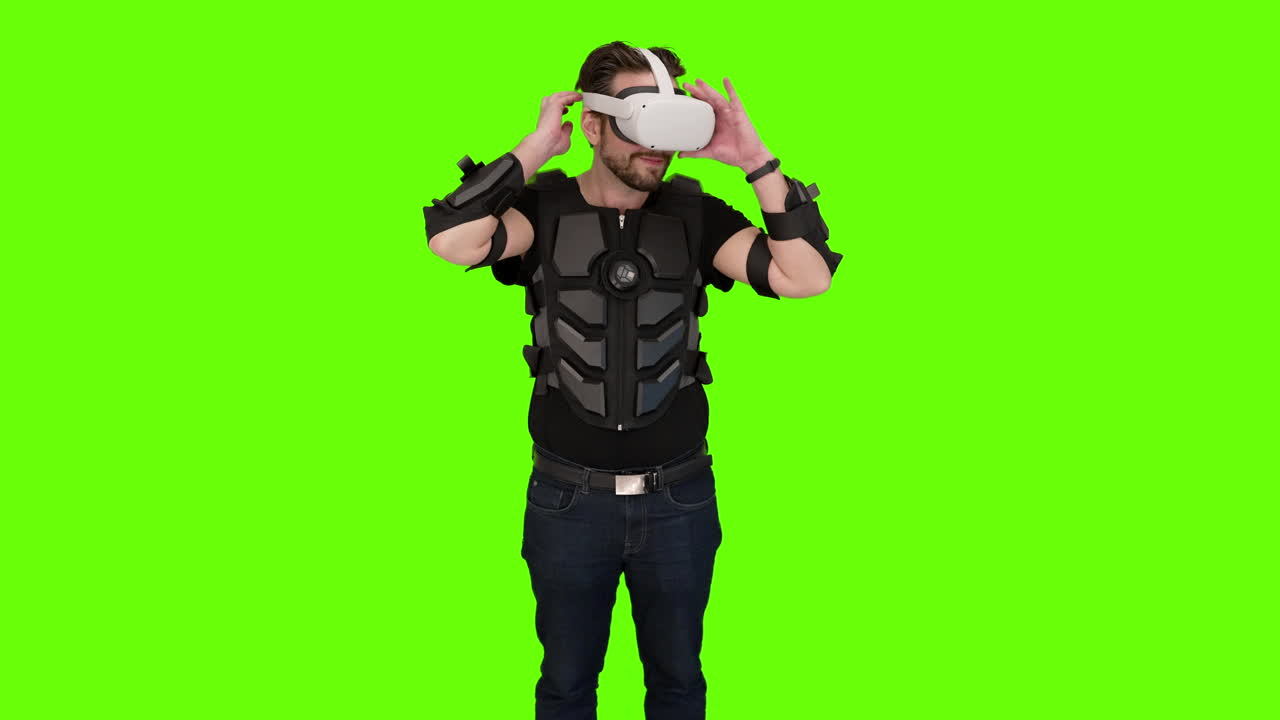Man put on white VR oculus quest gaming headset gear virtual reality futuristic immersive unreal experience nerdy game gamer setup computer brain rig screen display augmented AR green impressed screen