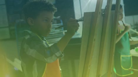 Animation-of-falling-dots-over-african-american-boy-in-art-classes