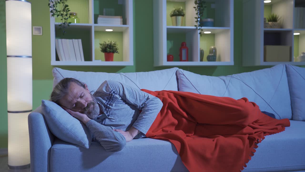 Confused thoughtful man having trouble sleeping at night.