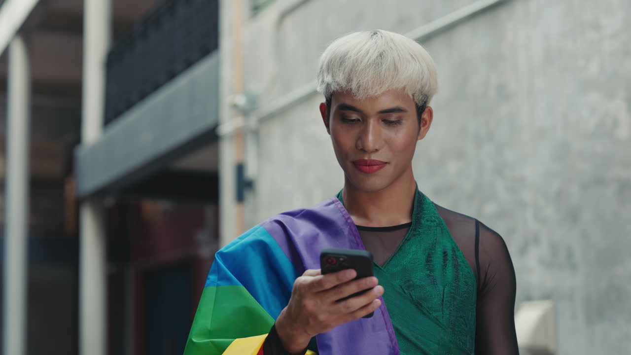 Smiling Person Using Smartphone with Pride Flag