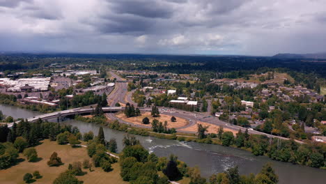 vehicles driving in oregon route 126 with interstate 105 over willamette river near city of eugene from kiwanis park in oregon