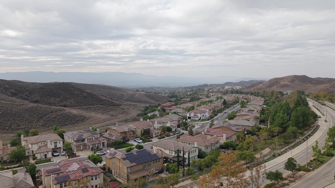 The aerial shot takes in sprawling neighborhoods framed by foothills, giving a sense of the valley’s broad, calm layout