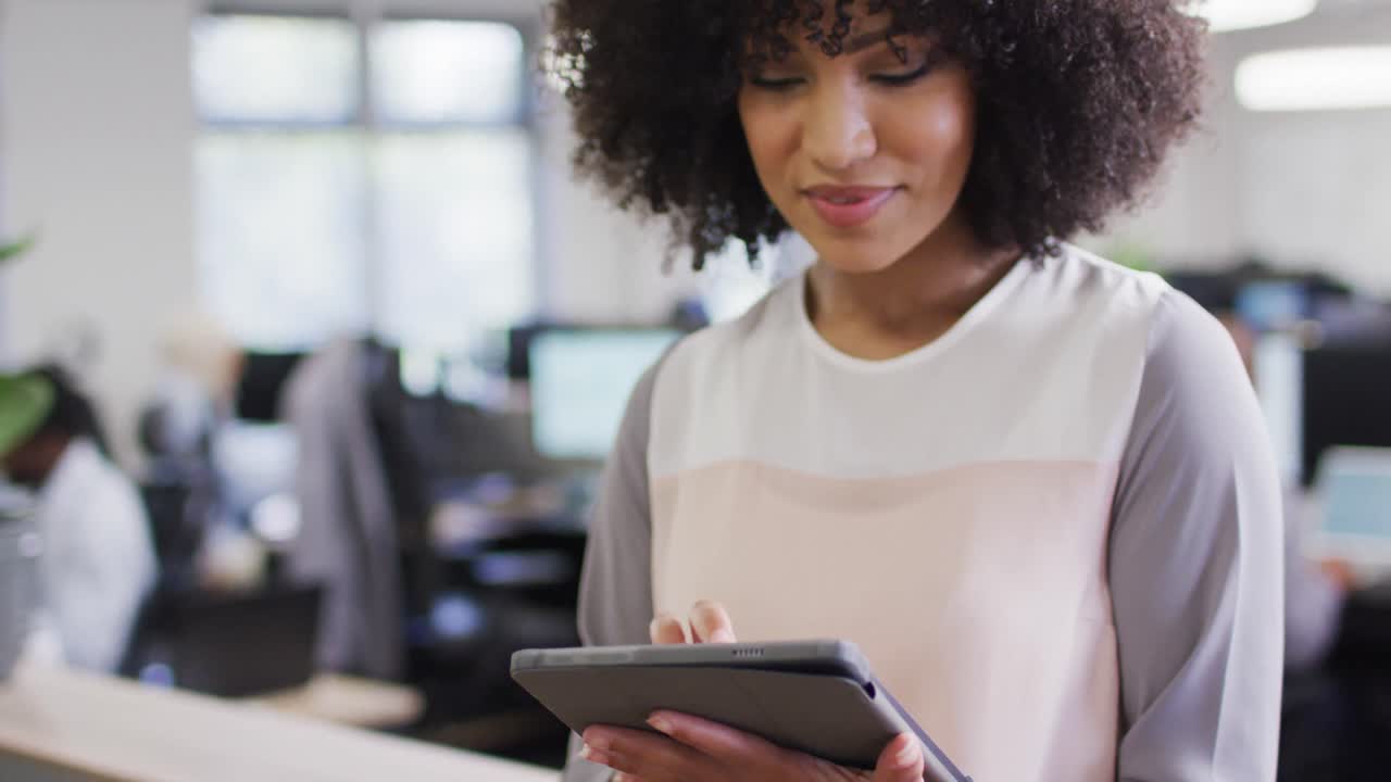 Portrait of happy african american businesswoman working with colleagues in office, slow motion