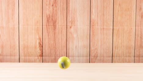 una pelota rebota repetidamente en una superficie de madera