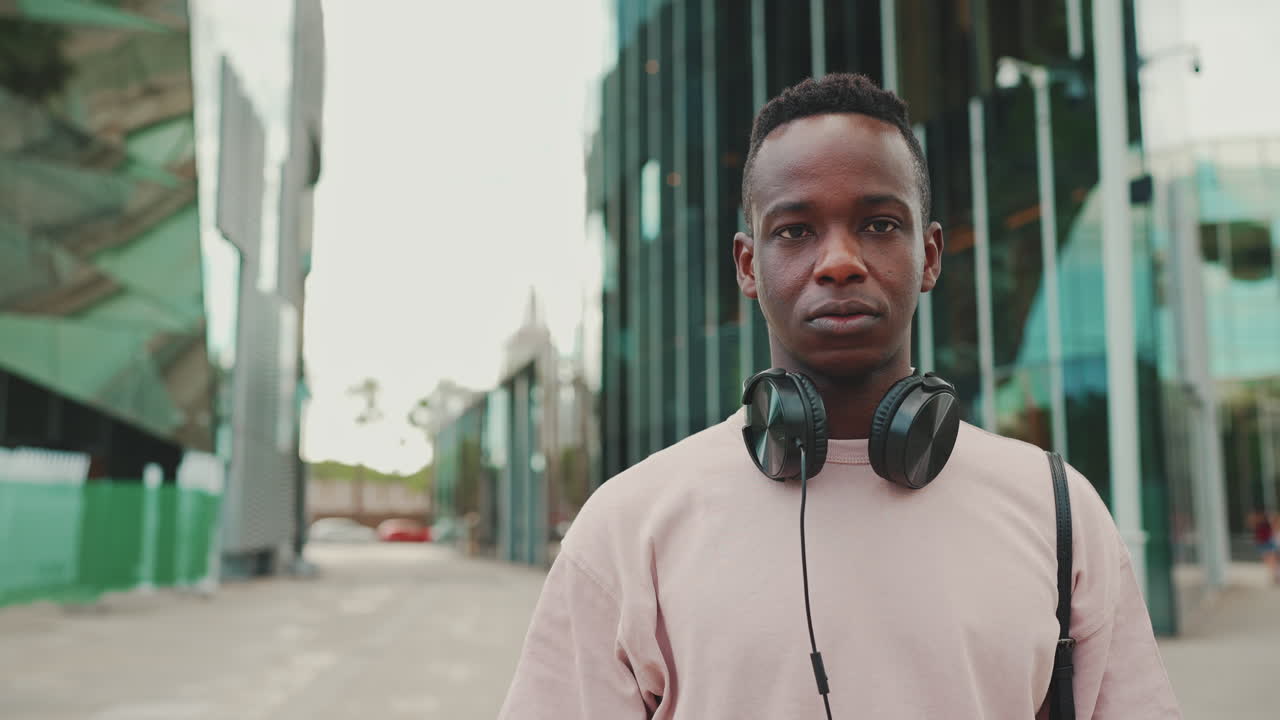 Portrait of a man with headphones in an urban setting