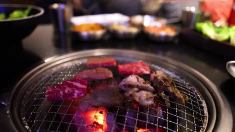 beef and bacon grilling on a restaurant grill