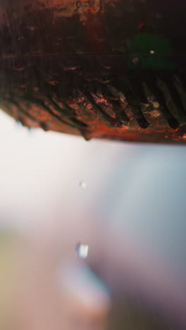 car wing mirror with dripping water drops at rain closeup. wet automobile detail at strong rainfall at countryside. splashing water on vehicle outdoors