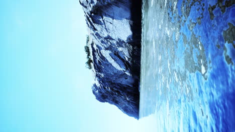 reflective cliff by the water