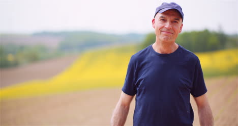 contented male agronomist gesturing on field 1