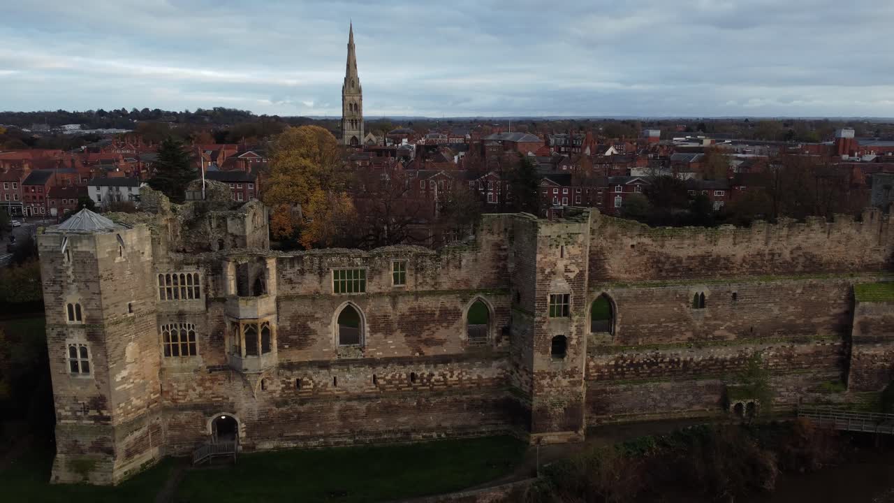Aerial view of a castle ruin and city skyline