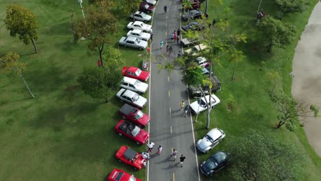 Vista-Aérea-De-Una-Exhibición-Callejera-De-Autos-Antiguos-En-Una-Ciudad-Metropolitana-En-Brasil