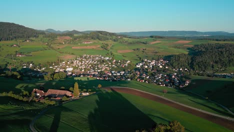 un pequeño pueblo en suiza desde el aire cuando sale el sol