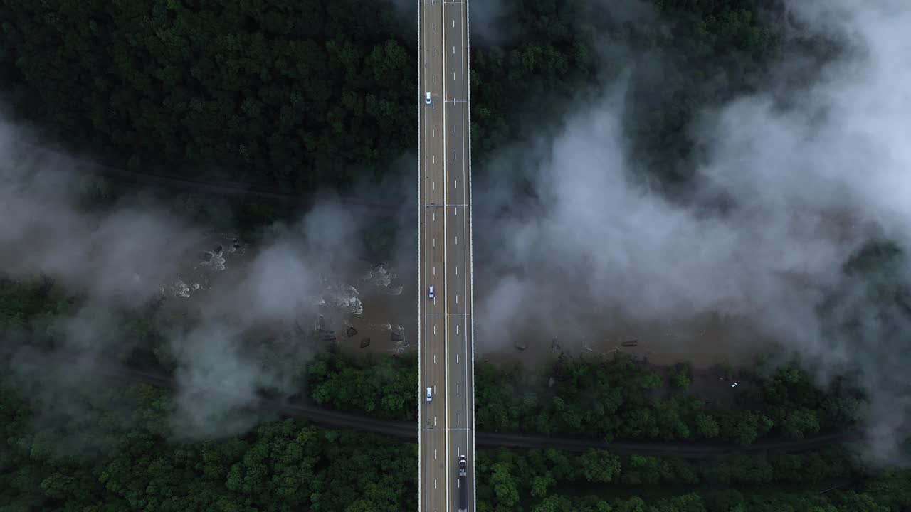 High Top Down Aerial View of Bridge Traffic Above Deep New River Gorge and Clouds, West Virginia USA. Cinematic Drone Shot