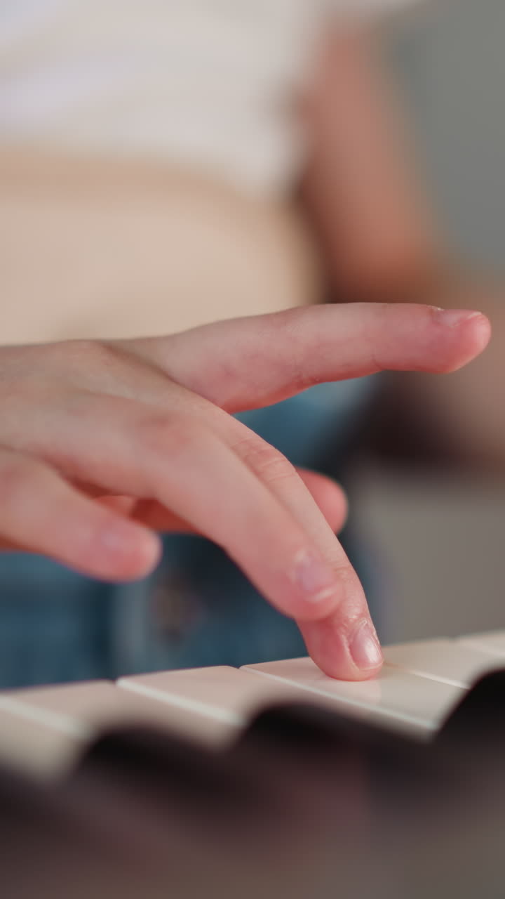 Girl with spinal cord injury plays piano standing in room at home. Talented child practices music during rehabilitation closeup on blurred background