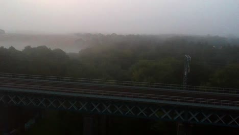 early morning foggy mist railway bridge - arches