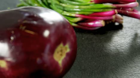 eggplant and scallions placed on grey surface 4k 4k