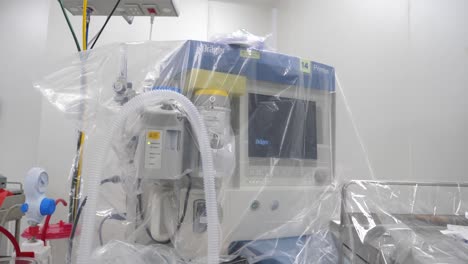 operating equipment cover with plastic drape before surgery in covid-19 pandemic situation