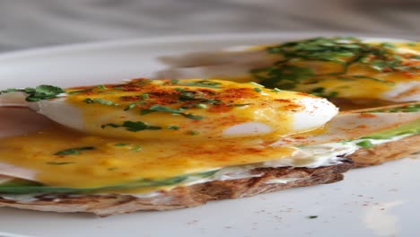 close-up of a delicious eggs benedict with avocado toast