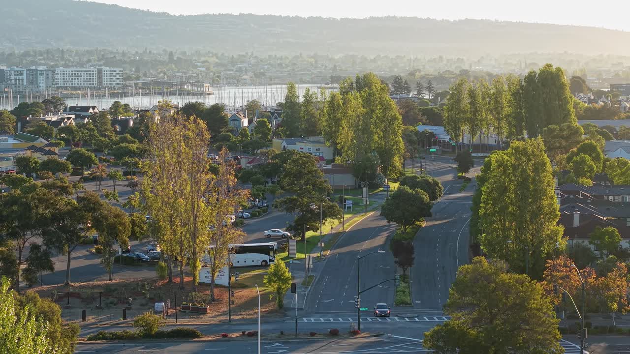 A drone pulls away revealing the Marina Village Parkway area in Alameda California during sunrise