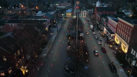 business storefront buildings on town decorated for christmas at night