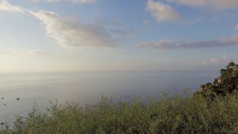 positano harbor from an overlooking balcony during a morning sunrise, panning right to left