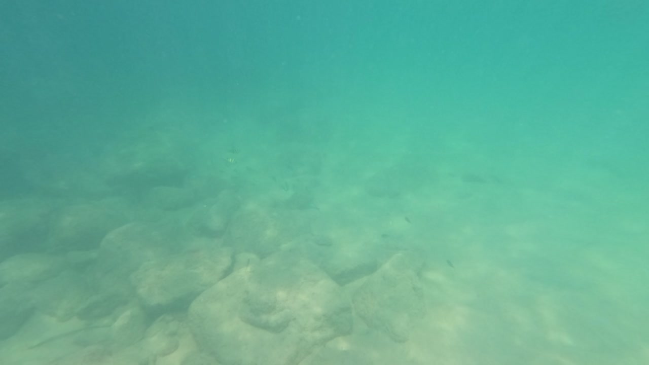 Underwater video showcasing rocky seabed and clear turquoise waters at Laem Singh Beach, Phuket, Thailand