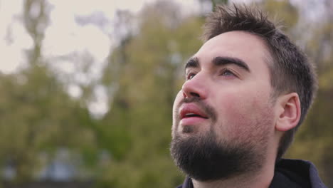 relaxed bearded man breathing fresh air standing in the park in the morning 1