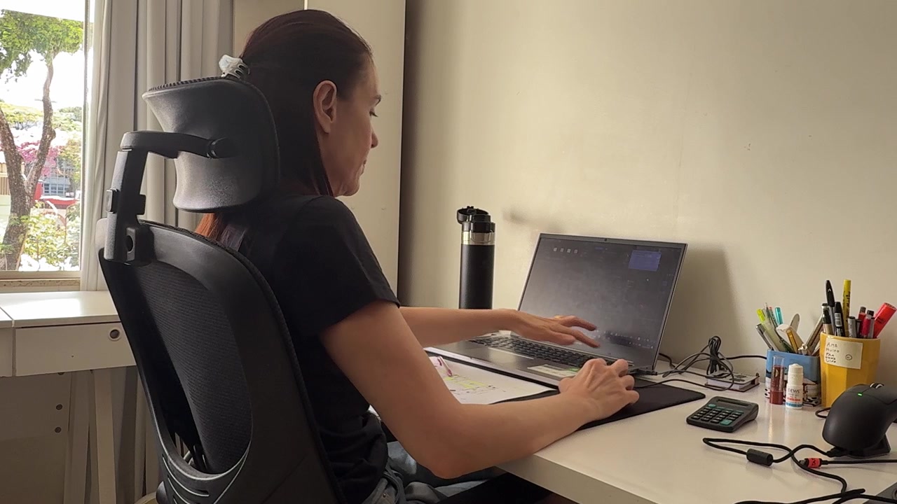 Donna matura che lavora da casa al computer portatile in un ufficio domestico dedicato, a illustrazione del lavoro da remoto, dell'impiego flessibile, della produttività digitale e della vita professionale moderna