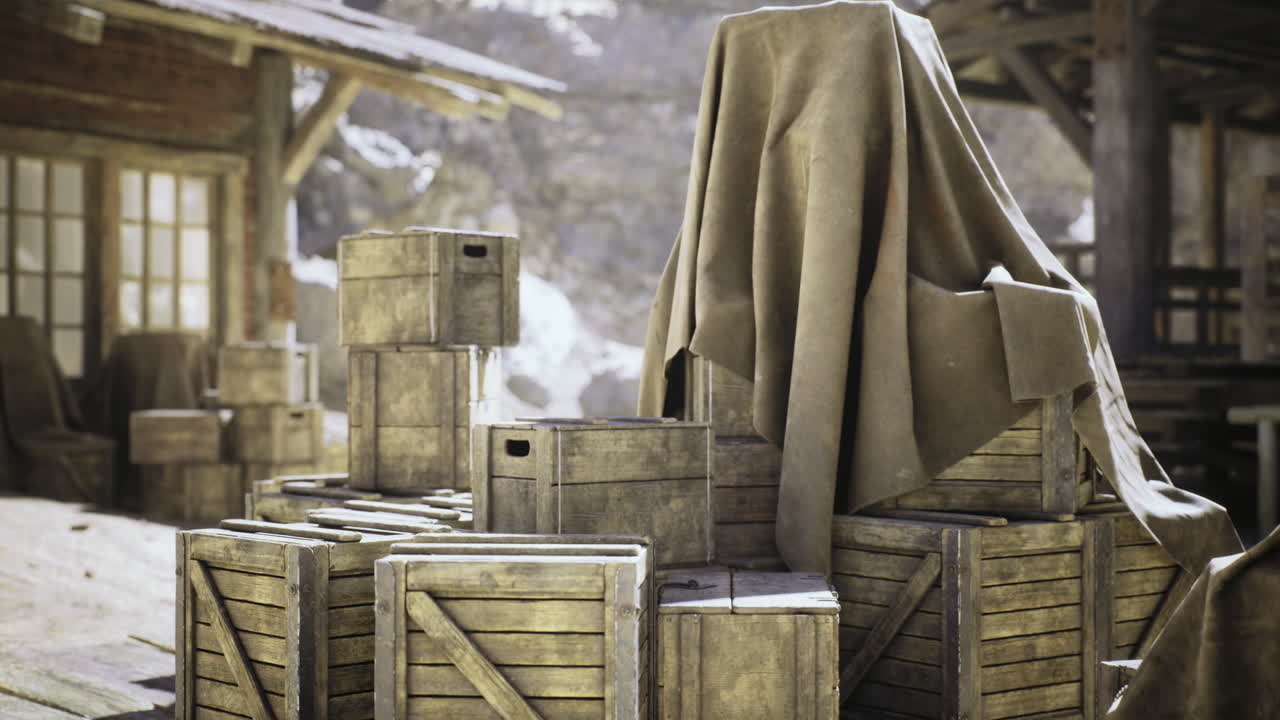 Wooden crates stack under a cloth in a rustic outdoor setting during daytime