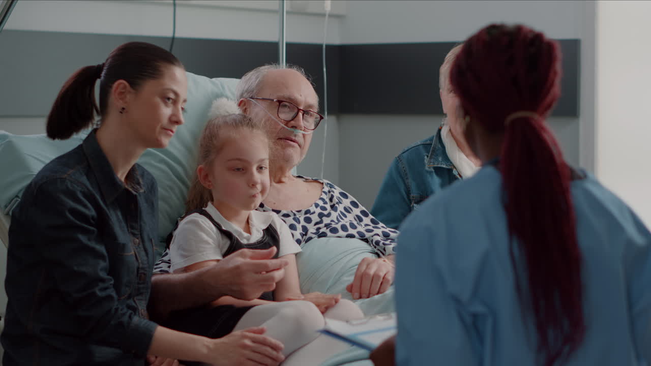 Close up of african american nurse talking to patient and his family