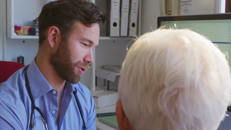 doctor examining a senior woman in a retirement home