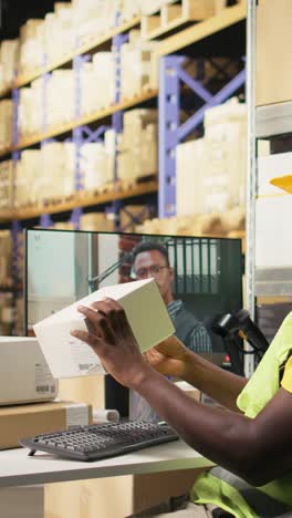vertical video warehouse clerk meeting on web video call with manager on computer