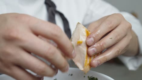 Diving-salmon-meat-into-pieces-and-adding-into-the-salad-bowl