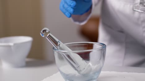 a pta is carefully trying to pour a liquid from a thin container into a glass bowl to mix a cream