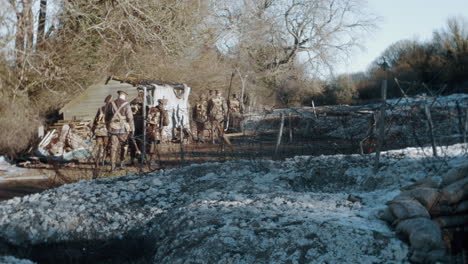 World-War-1-soldiers-marching-across-a-battle-field-of-tenches-in-the-winter