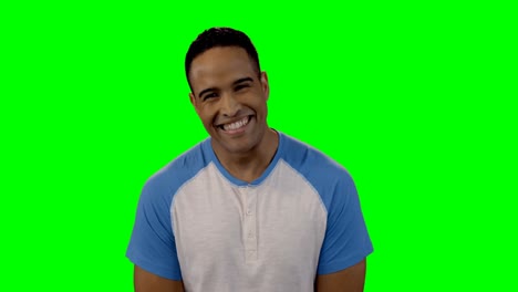 Smiling-man-standing-against-green-screen