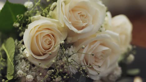 closeup of beautiful bouquet of white roses with green foliage designed for a wedding