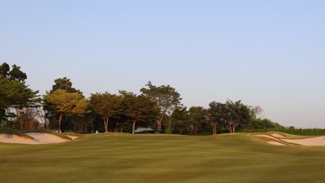 a tranquil golf course during a serene sunset