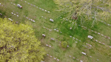 cemetery-graveyard-drone-aerial-footage-Grand-Rapids-Michigan-with-green-foliage-and-trees-and-gravestones