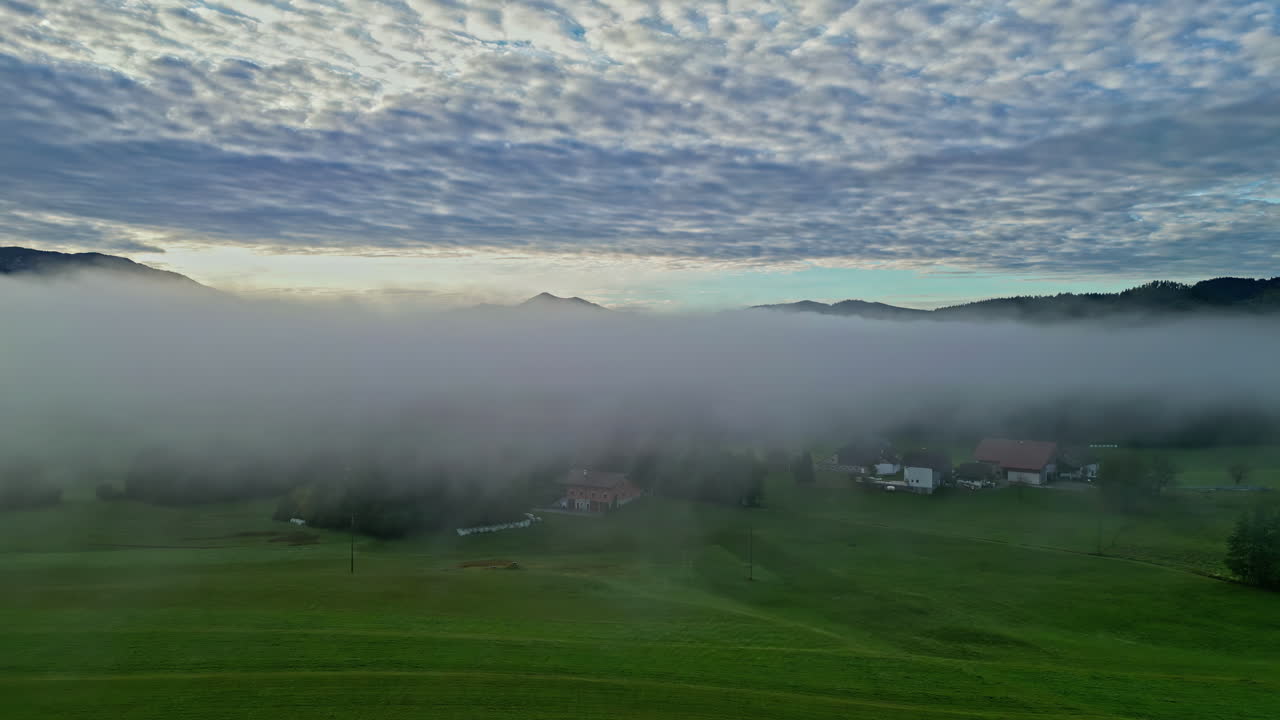 해가 뜨는 동안 구름이 어지고 집들이 어져 있는 안개가 인 계곡, 공중 사진
